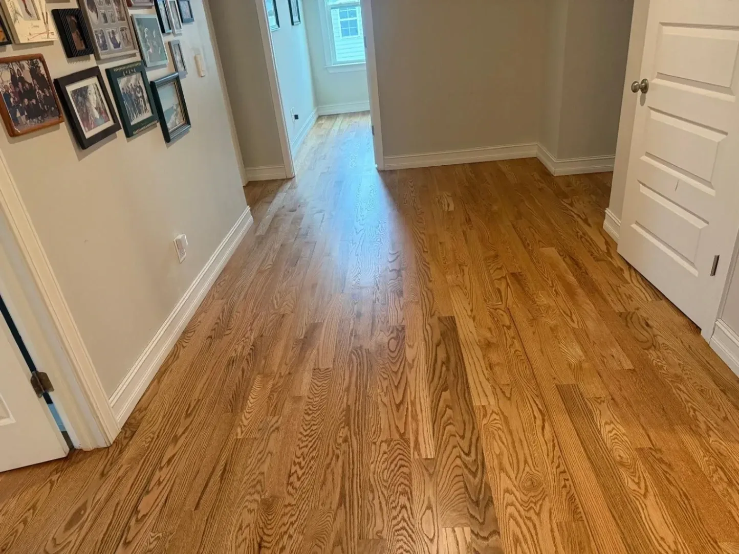 Newly installed natural oak hardwood flooring in a hallway by DNH Hardwood Flooring in Clayton, NC.