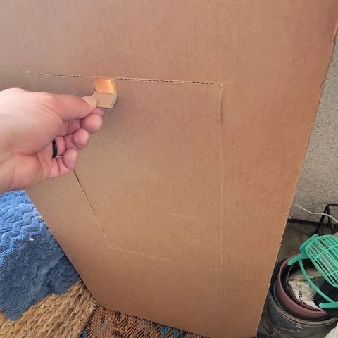 Sky OG. growlog photo: So I decided that I needed someking of vent for airflow if I wasn't committing to a fan inside the tent so I made an cutout window with a mesh for pest protection (also keep my cat out) . I also added a curtain of mylar draped down with a slit down the middle that way there is is a little light reflected In that direction rather than none. after about 15 minutes,  the temperature was around for 74-76 degrees and the humidity dropped 10% percent from 85% to 74%! The humidity hasn't been that low since I got the plant and started monitoring the RH/ temp. Seems like this will work for now. Will cover it over night and vent it out in the afternoons. 