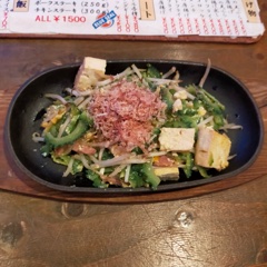 Bitter melon stir-fry served on an iron plate