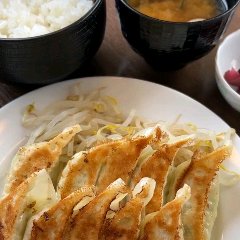 Simple set meal of gyoza, bean sprouts, pickles, soup and white rice