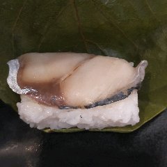 Thin mackerel fish served on persimmon leaf sushi