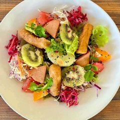 Brown rice dressed with homemade yeast miso under seasonal vegetables and fruits