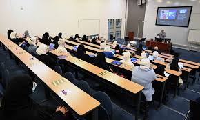 Kuwait university student studying confidently with laptop and notes using academic support