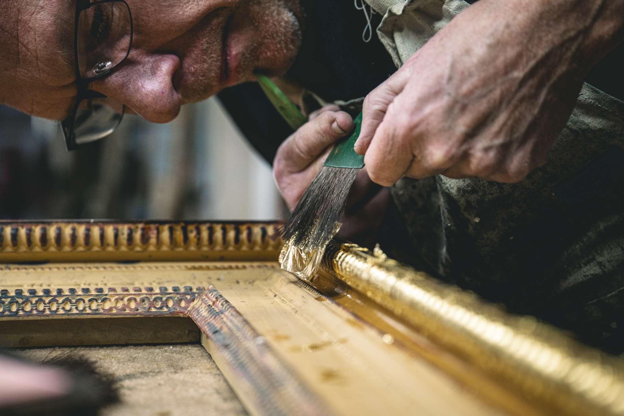 Long-time gilder, Ed, showing the gilding technique