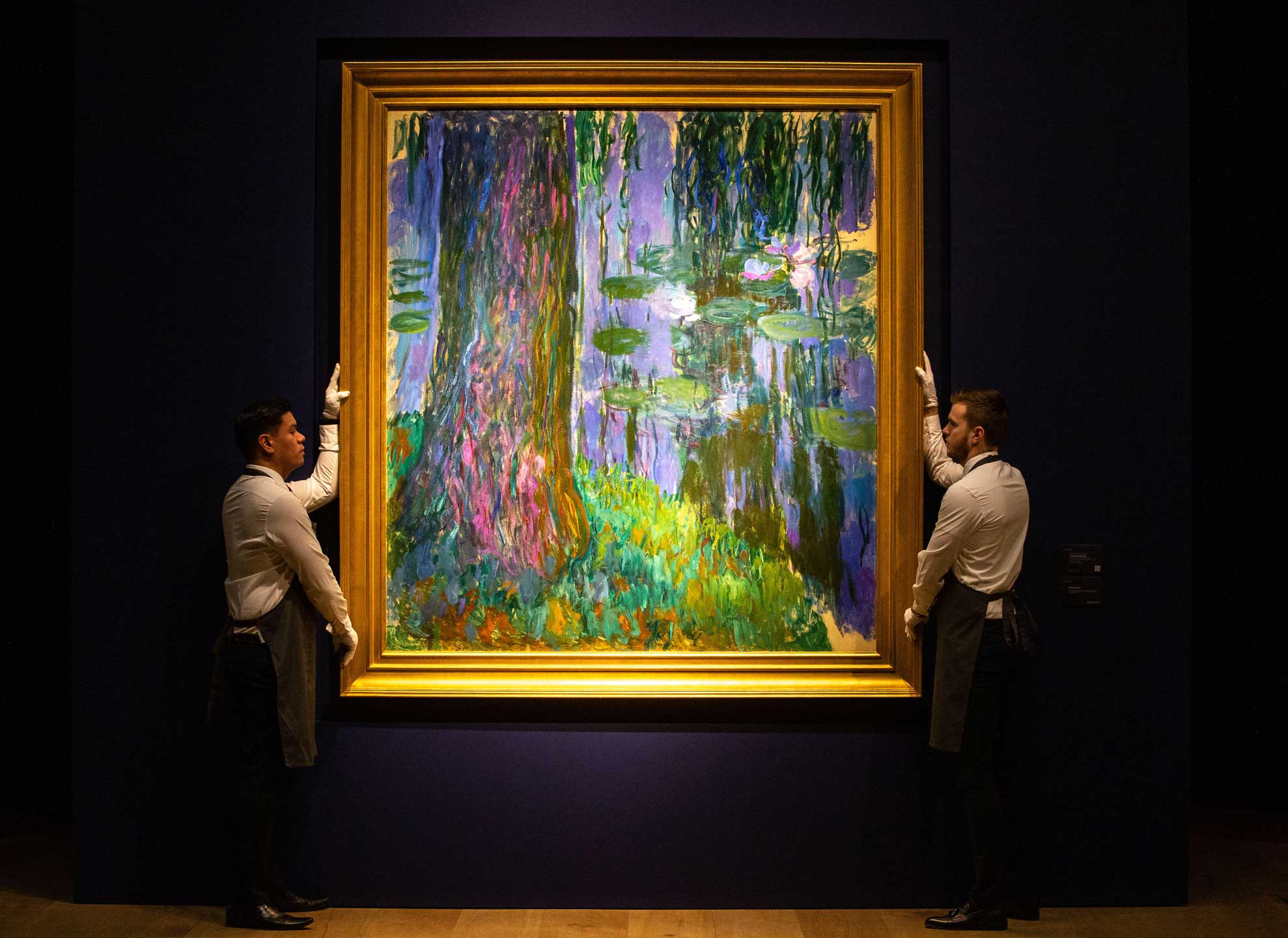 London, UK. 21st Feb, 2019. Christie’s staff make final adjustments to Claude Monet’s ‘ ‘Saule Pleureur et bassin aux nympheas’ estimated at at least £40 Million. The Christie’s ‘Impressionist and Modern Art’ sale and ‘The Art of the Surreal’ sale.