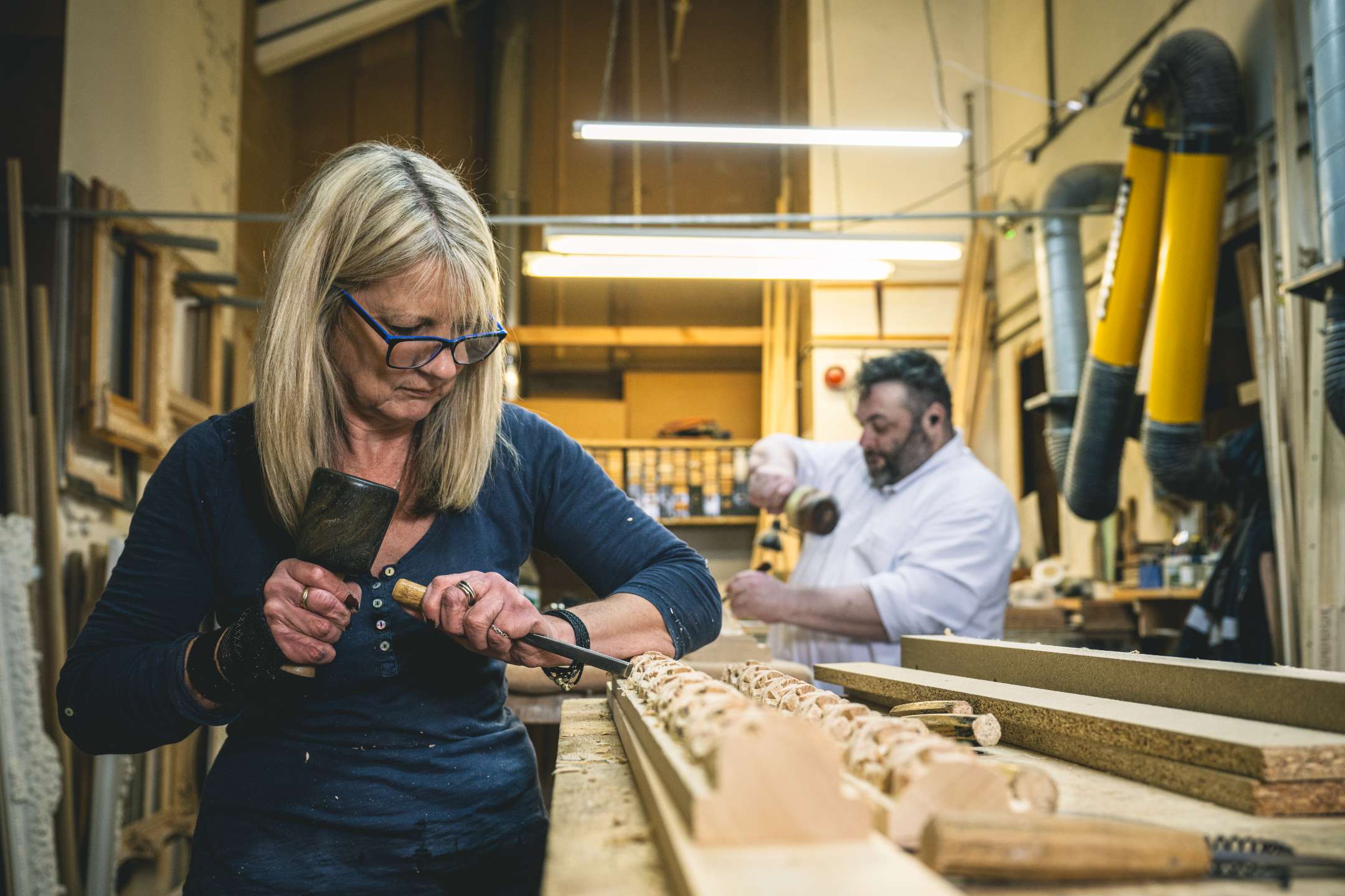 One of our talented carvers, Suzette, working on a similar frame