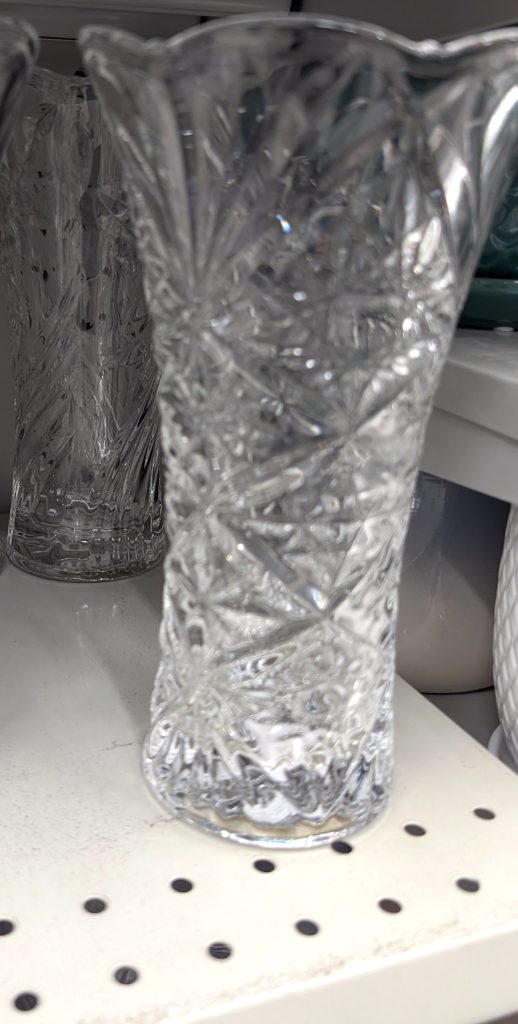 Clear glass vase with intricate cut-pattern design from Dollarama, $3, perfect for home decor and floral arrangements.