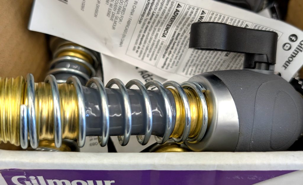 Gilmour High Flow Faucet Adapter with kink-free coil, brass and gray, for improved water flow, available at Walmart.