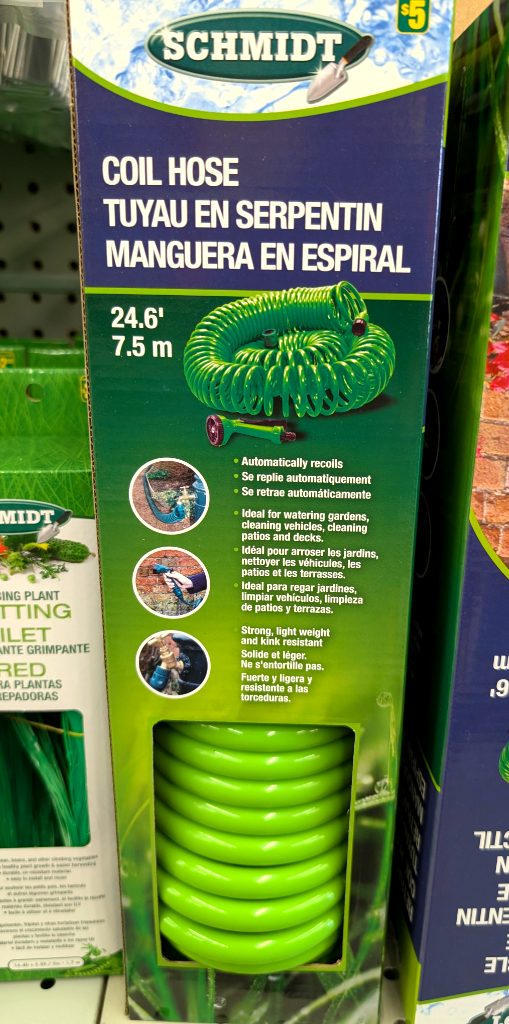 Green Schmidt 24.6 ft coil garden hose with nozzle for watering and cleaning, available at Dollarama for $5.