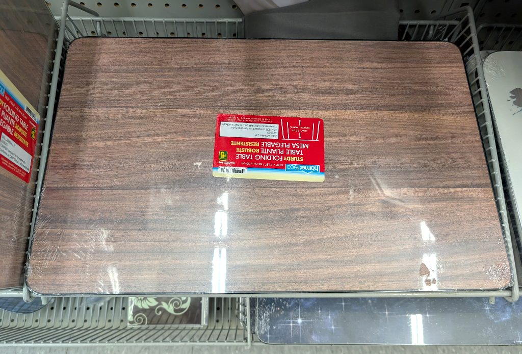 Wood grain finish sturdy folding table from Dollarama, ideal for small spaces or temporary use, priced at $5.