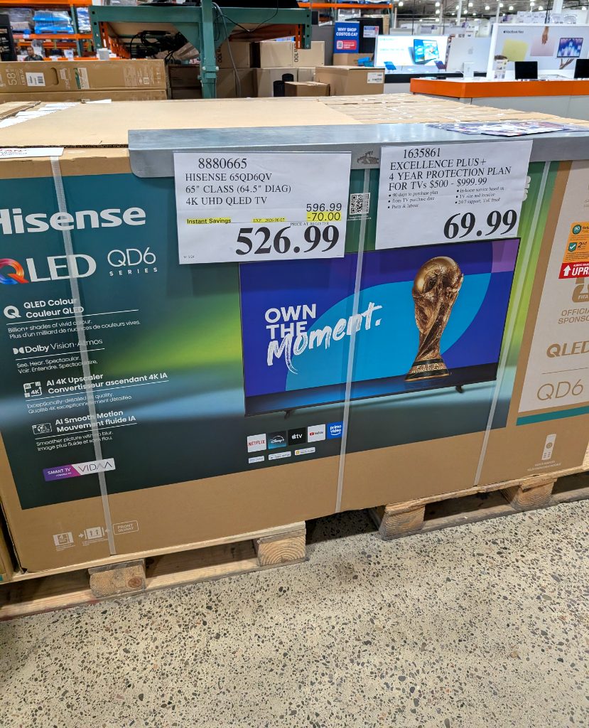 Hisense 65-inch QLED 4K UHD Smart TV in its packaging at Costco, a powerful smart TV for home entertainment.