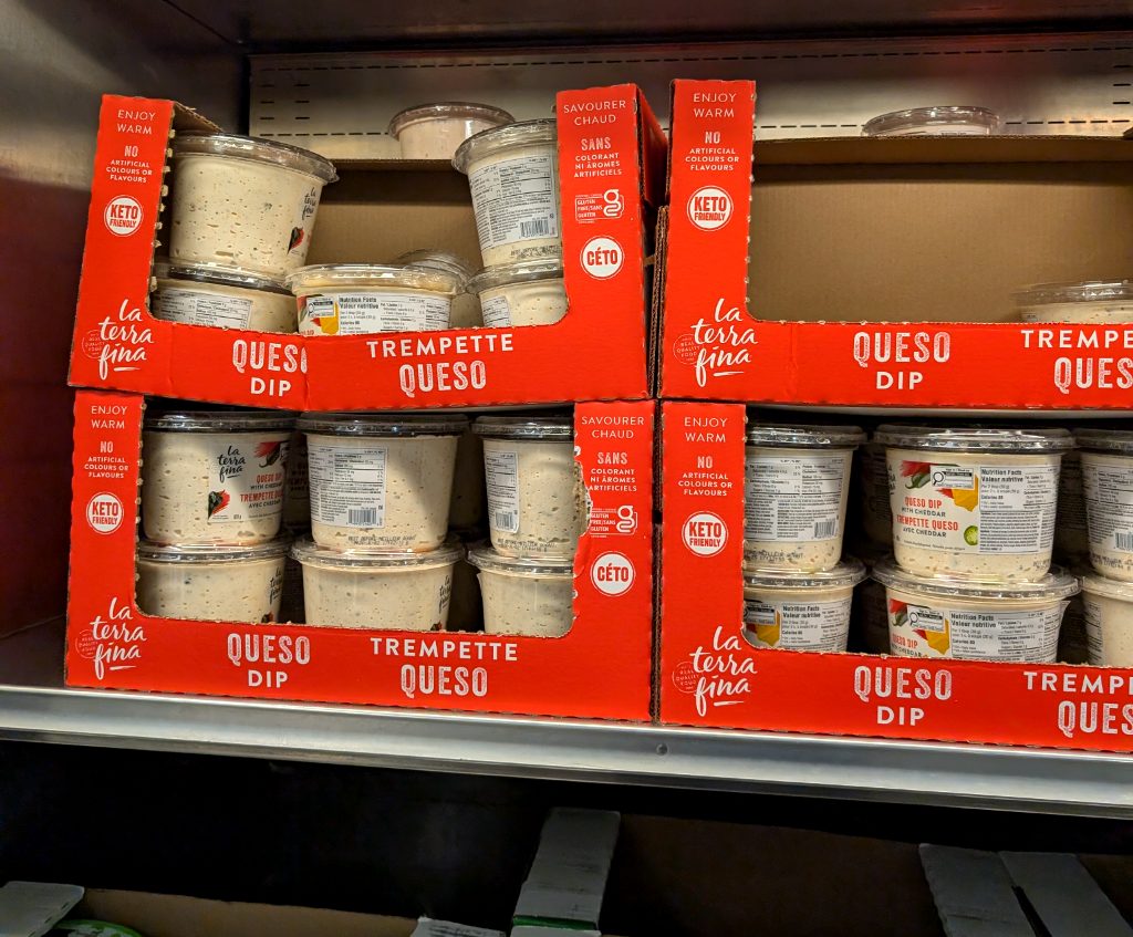 La Terra Fina Queso Dip with Cheddar, a creamy white dip in clear plastic containers, sold at Costco for $9.99. Keto friendly.
