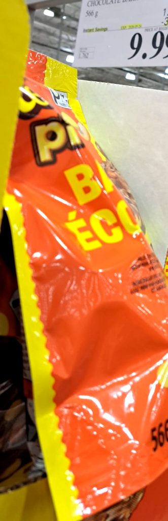 Large orange bag of Reese's Pieces Chocolate Bark from Costco, priced at $9.99, perfect for sharing.