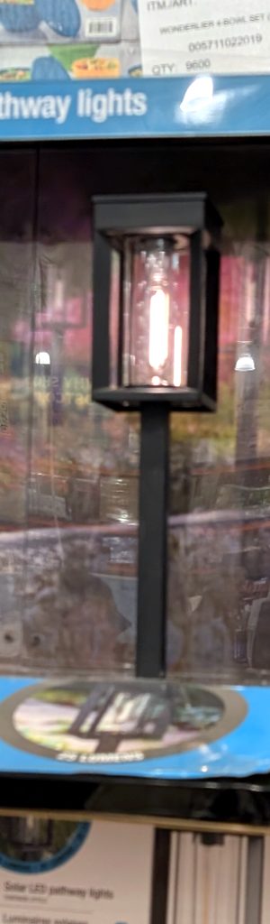 Natural Solar LED pathway lights 4-pack from Costco, $29.99, featuring a black design with a warm glow bulb.