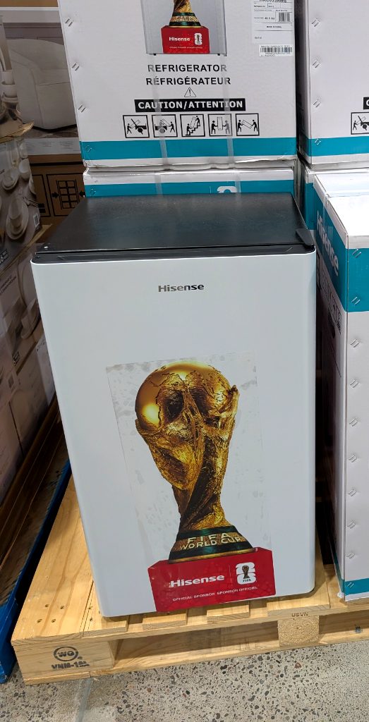 White Hisense mini-refrigerator with FIFA World Cup 2026 trophy graphic, ideal for a sports fan's room from Costco.