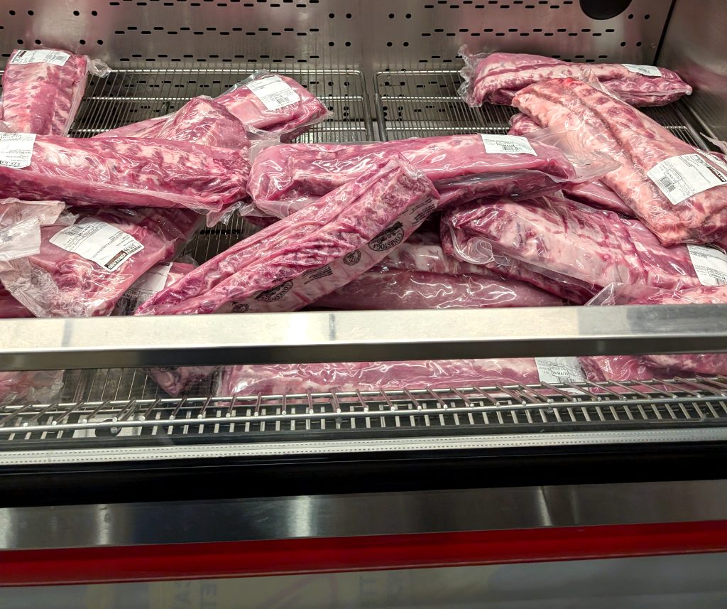 Kirkland Signature pork back ribs, vacuum-sealed, on sale at Costco. Ideal for grilling or slow cooking. $5.00 off.