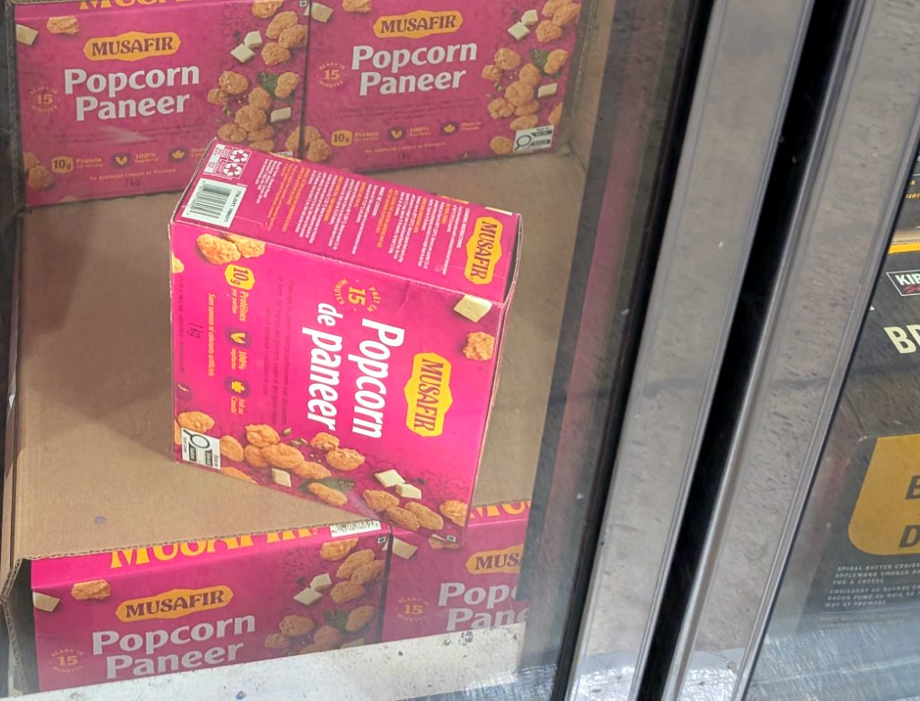Pink box of MUSAFIR Popcorn Paneer, a vegetarian frozen food item, available at Costco for $9.97.