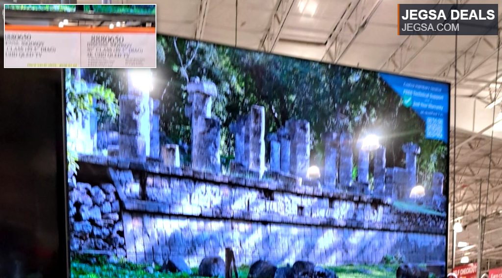 Hisense 58-inch 4K UHD QLED TV displaying ancient ruins, available at Costco for $346.99, mounted on an orange shelf.