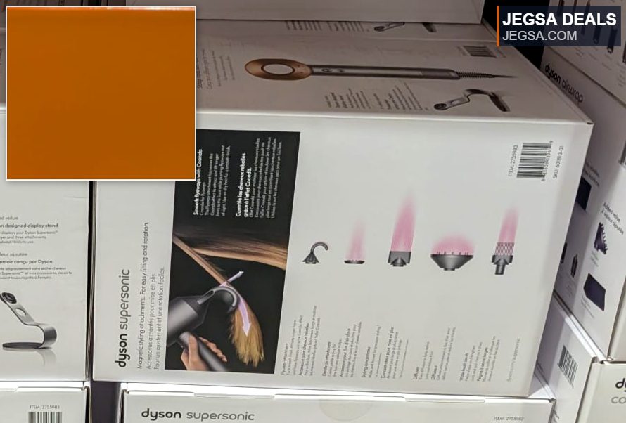 Dyson Supersonic hair dryer in silver/bronze with multiple attachments, found at Costco for $479.99, offering fast drying without extreme heat.