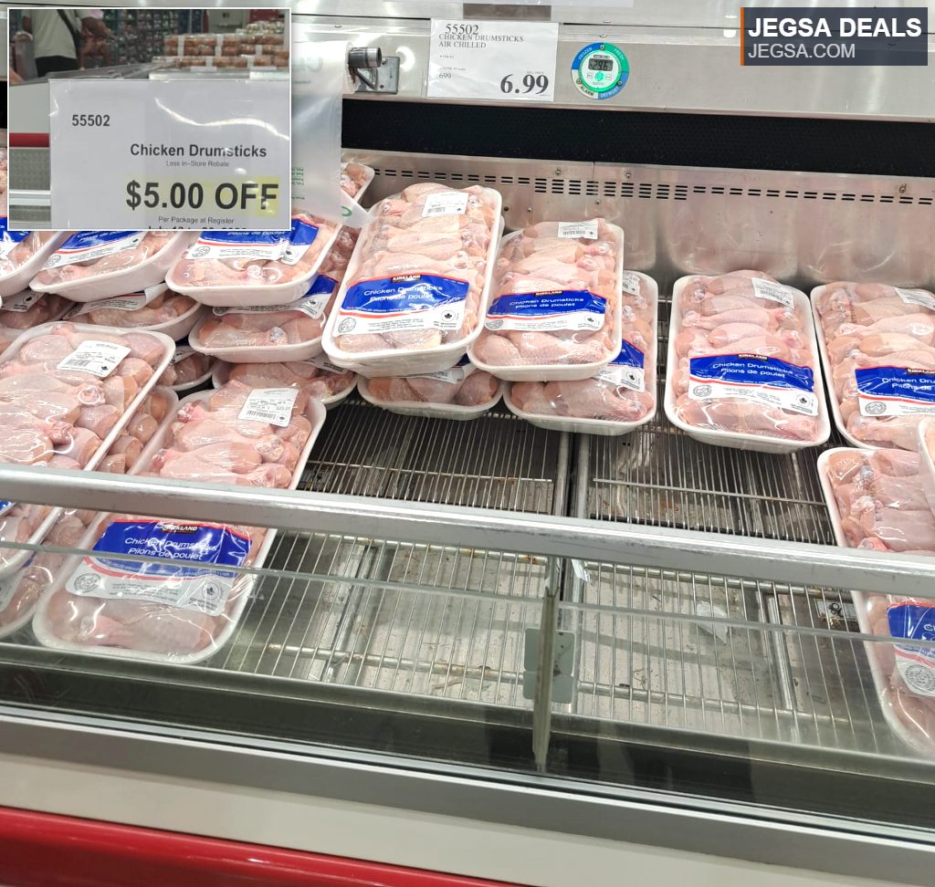 Kirkland Signature fresh chicken drumsticks in a refrigerated display at Costco, priced at $6.99 before discount.