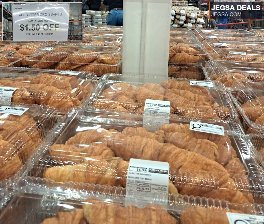 Golden all-butter croissants in clear bulk packaging on display at Costco, offered with an in-store rebate.