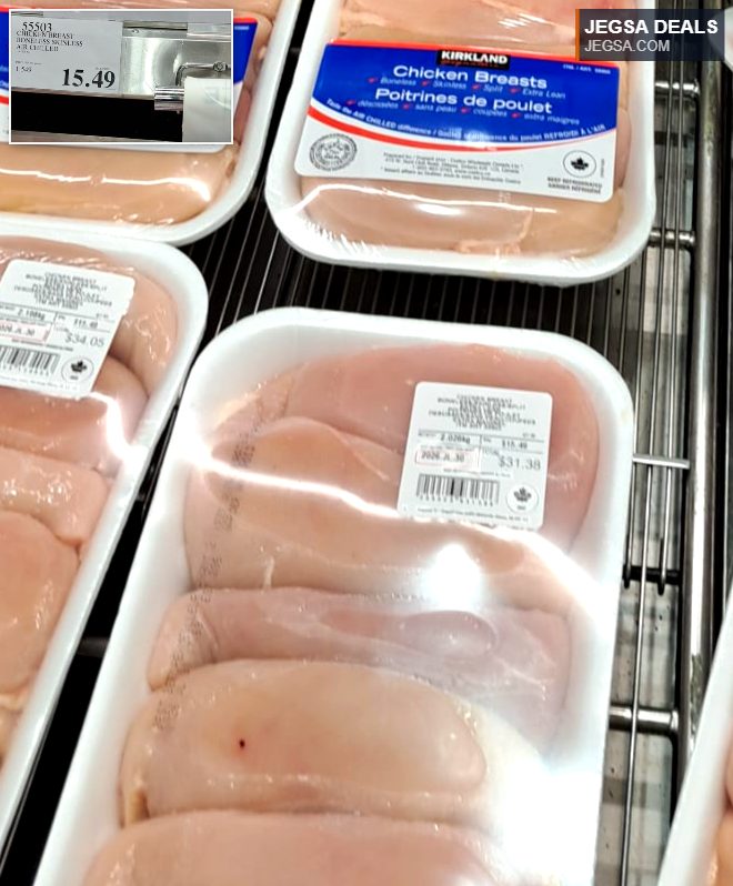 Fresh Kirkland Signature boneless skinless chicken breasts from Costco, displayed in a refrigerated case.