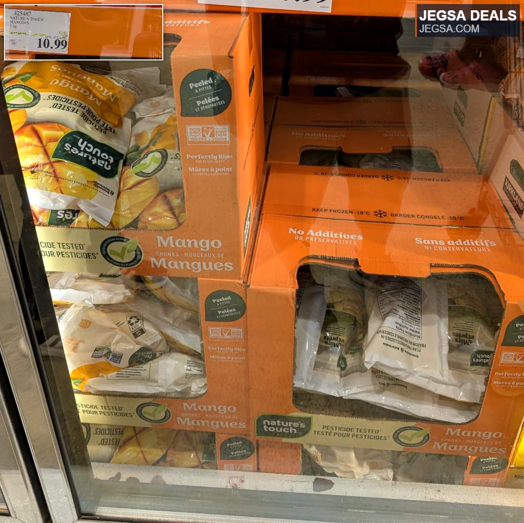 Nature's Touch 2 kg bag of peeled, pitted mango chunks in a refrigerated display at Costco, priced at $10.99.