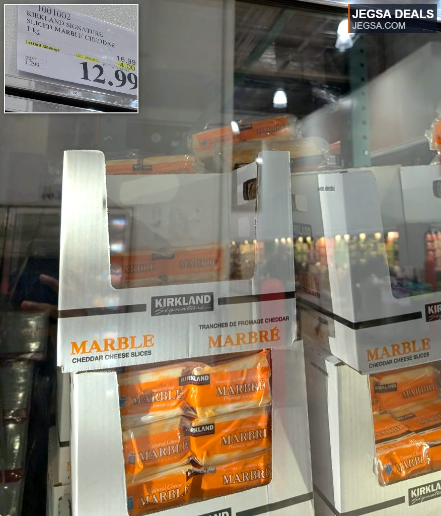 Kirkland Signature 1 kg sliced marble cheddar cheese in a refrigerated display at Costco, priced at $12.99.