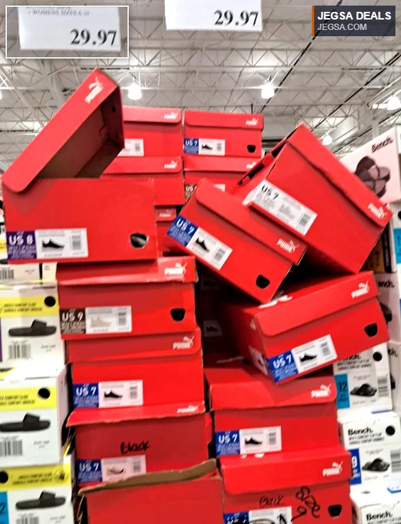Red Puma women's sneakers in various sizes on display at Costco, priced at $29.97 per pair.