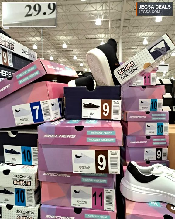 Skechers Memory Foam sneakers in white/black and black, displayed in boxes at Costco for $29.97, ideal for casual wear.