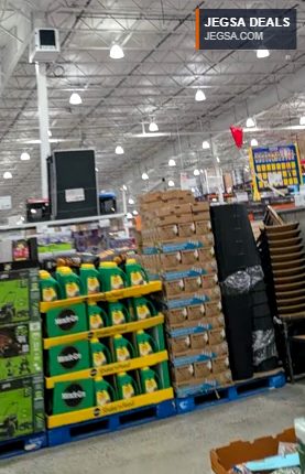 Miracle-Gro Shake 'N Feed Plant Food in green and yellow bottles at Costco, providing essential nutrients for plants.