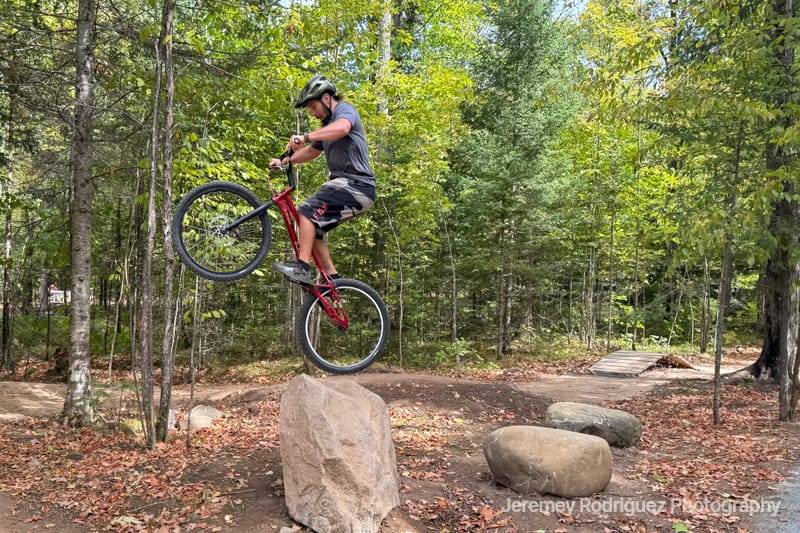 Mountain Biker Balancing on a Boulder