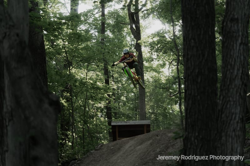 Mountain Biker Flying Off a Wooden Ramp