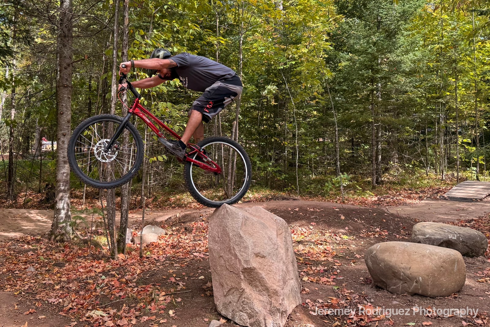 Mountain Biker Pivoting on a Boulder