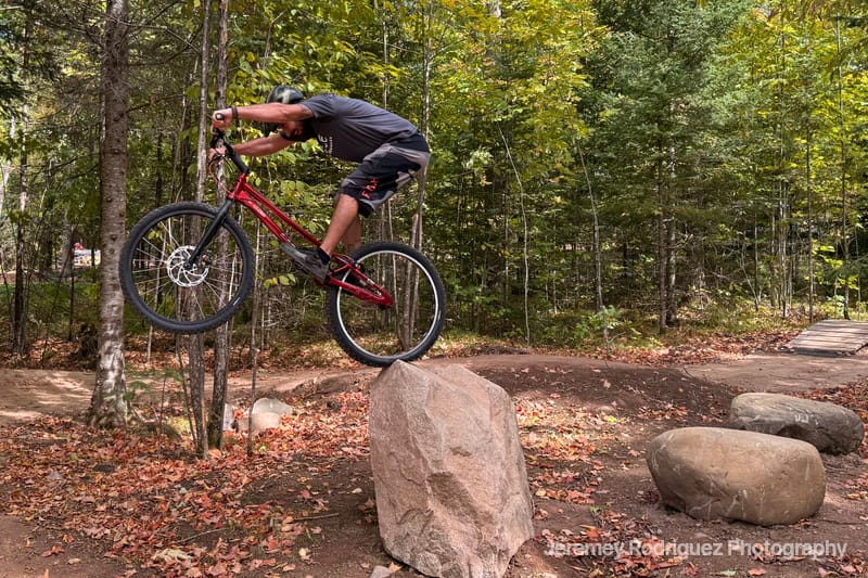 Mountain Biker Pivoting on a Boulder