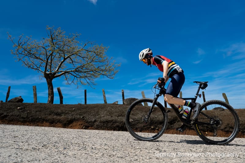 Mountain Biker Cruising a Sunny Gravel Road