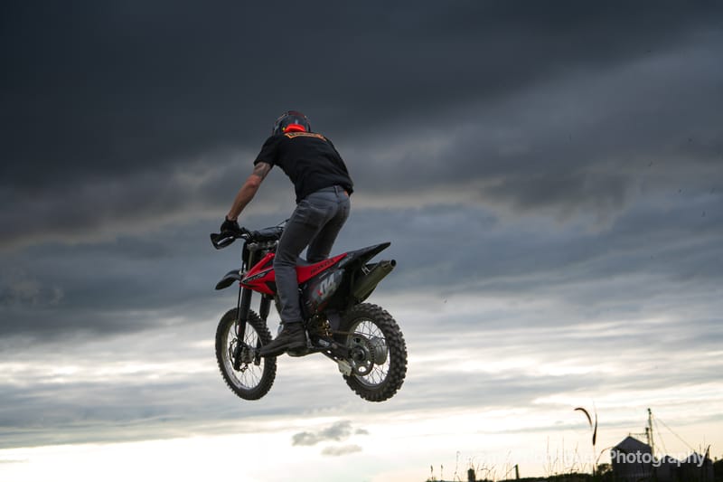 Silhouetted Dirt Bike Jump at Dusk
