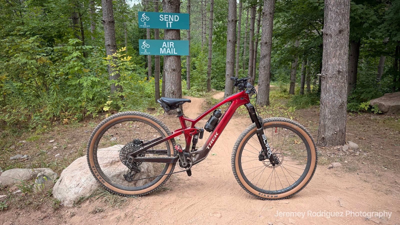 Red Mountain Bike at a Trail Sign