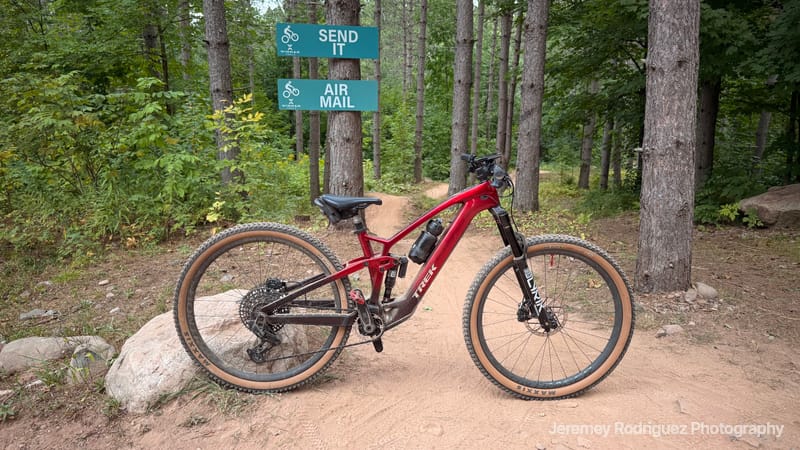 Red Mountain Bike at a Trail Sign