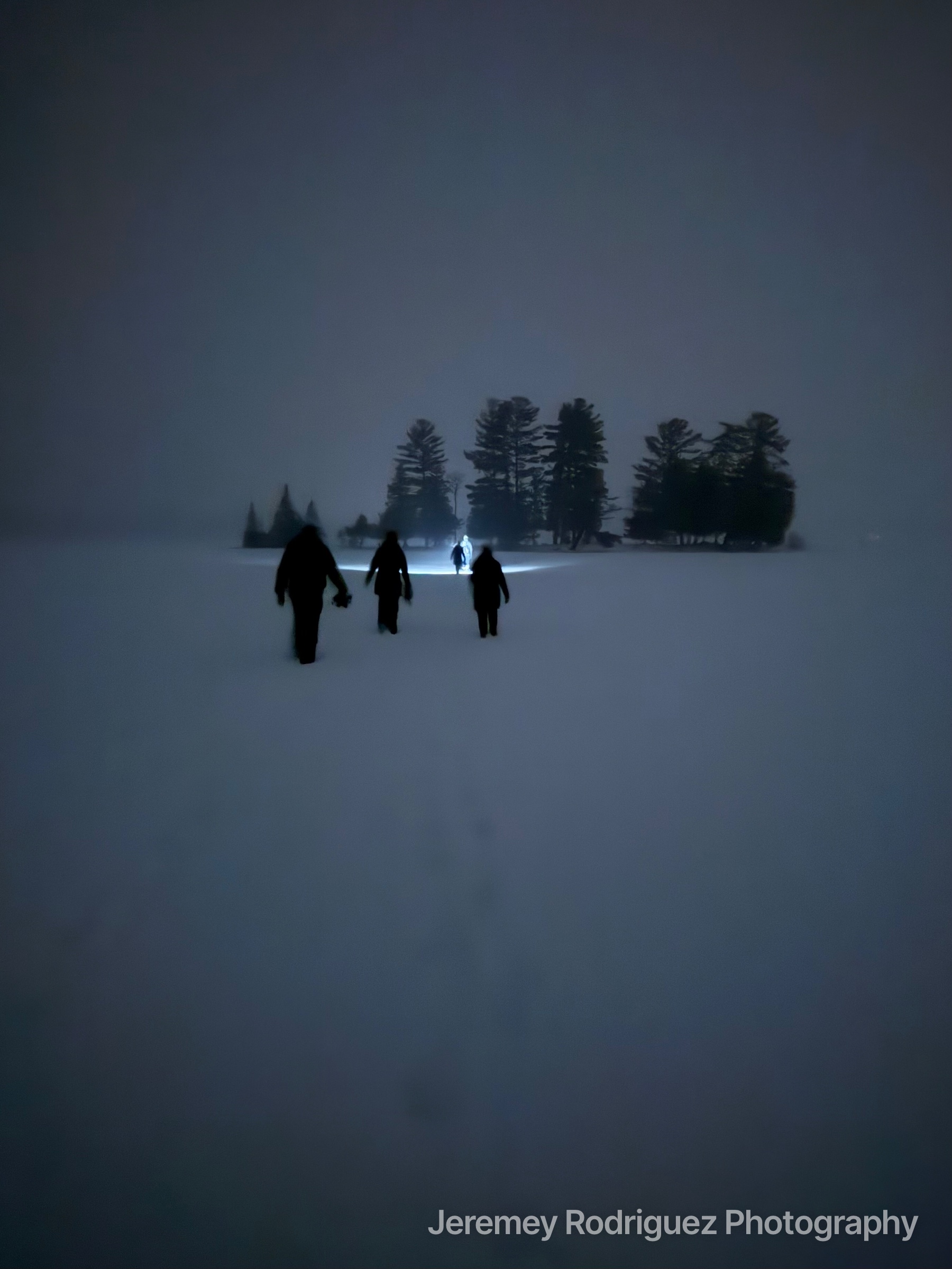 Friends Walking Across a Foggy Frozen Lake at Night
