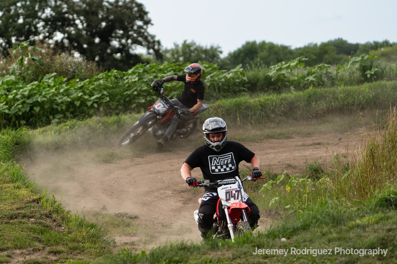 Dirt Bikes Kicking Up Dust on a Berm