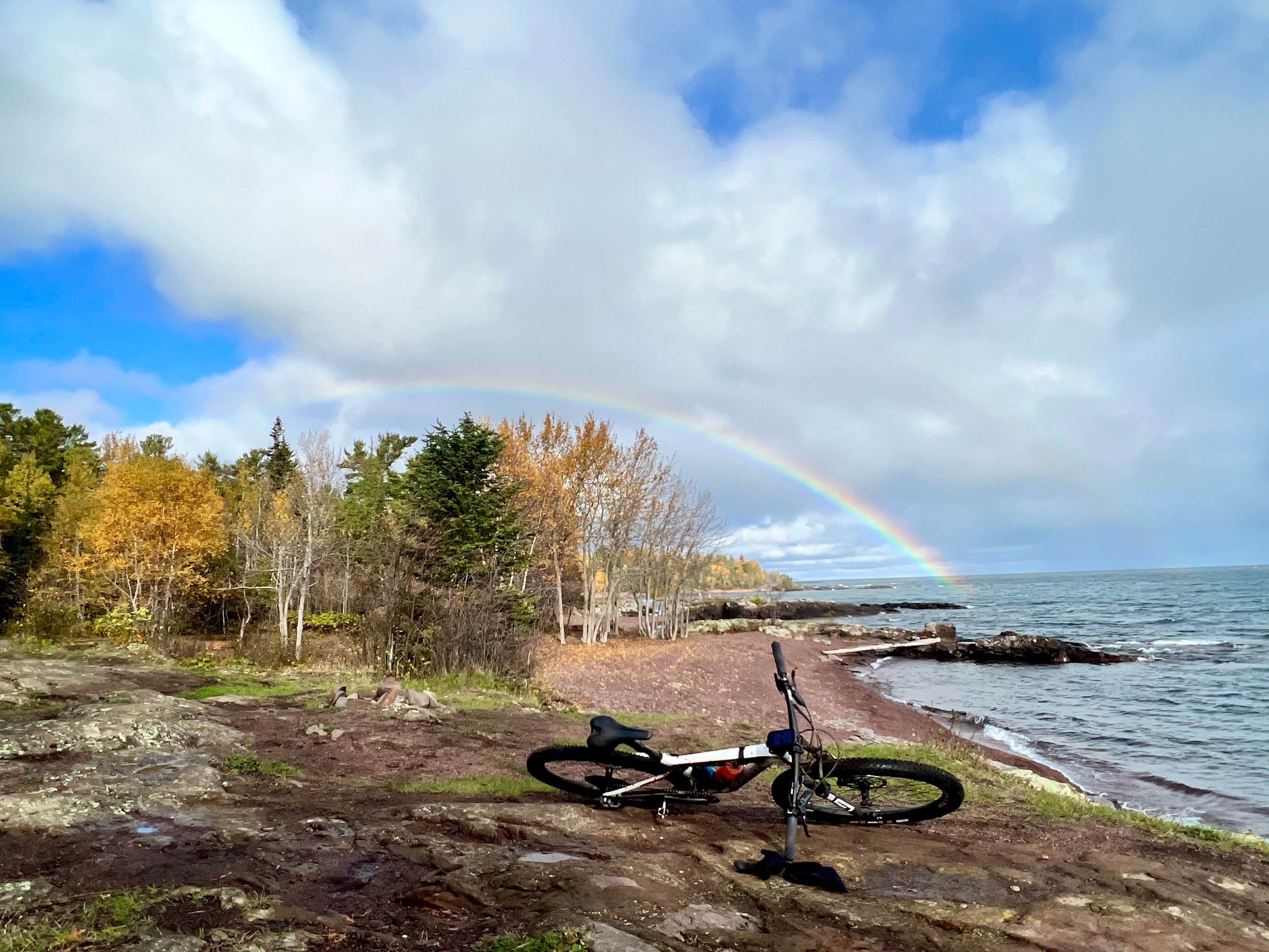 Copper Harbor Bikes Resting by a Lakeshore Rainbow