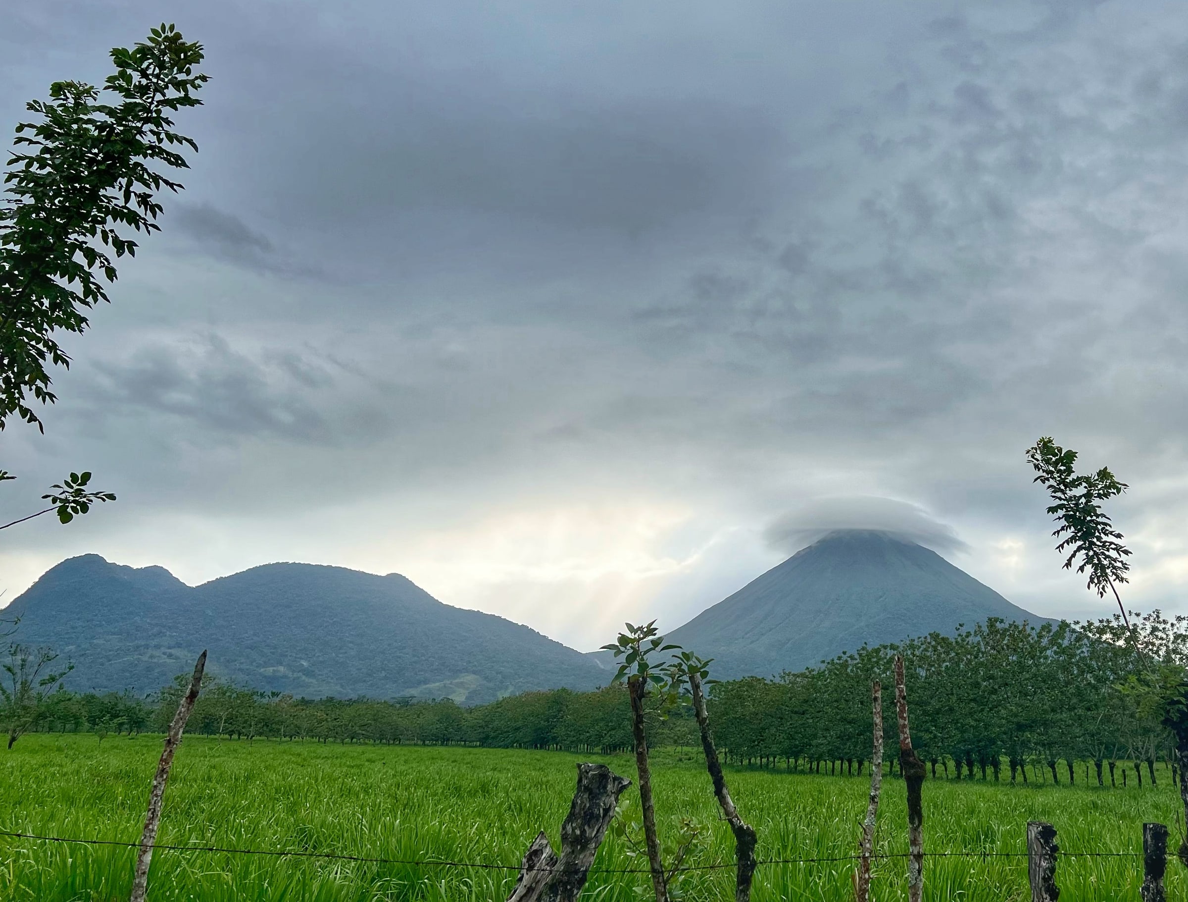 Costa Rica Tropical Volcano Peaks Over Green Fields