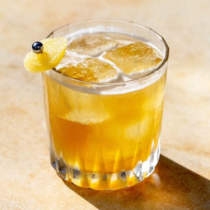 Penicillin cocktail in a lowball glass with clear ice