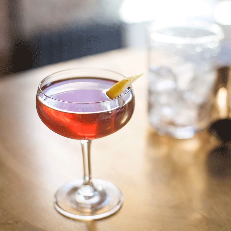 The Bobby Burns cocktail in a coupe glass with lemon twist