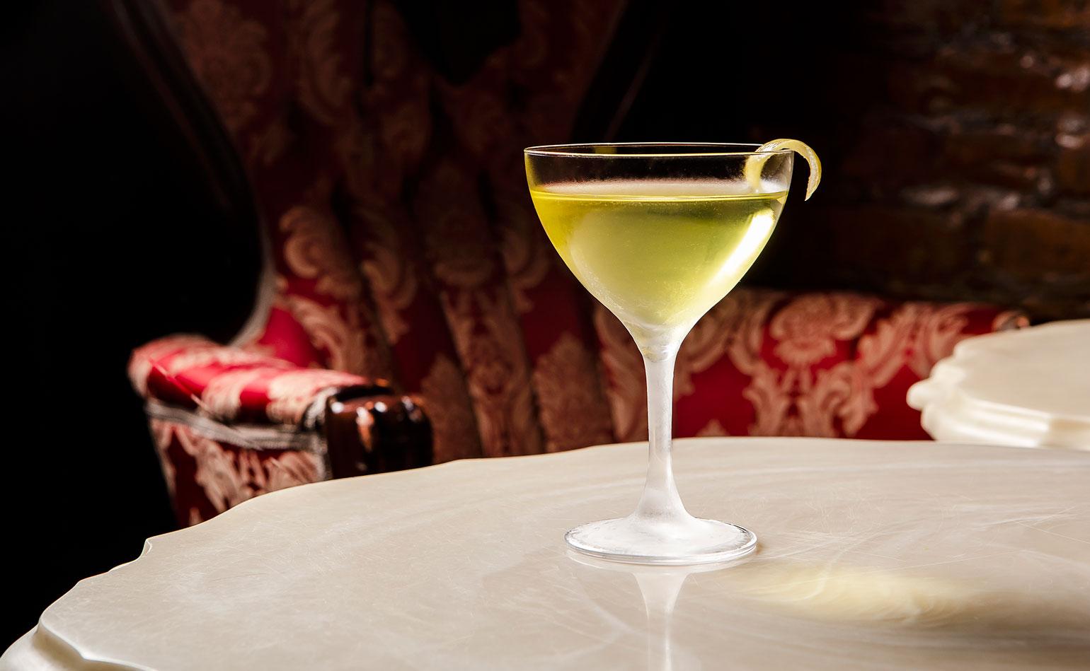 Alaska Cocktail in a coupe glass with lemon garnish