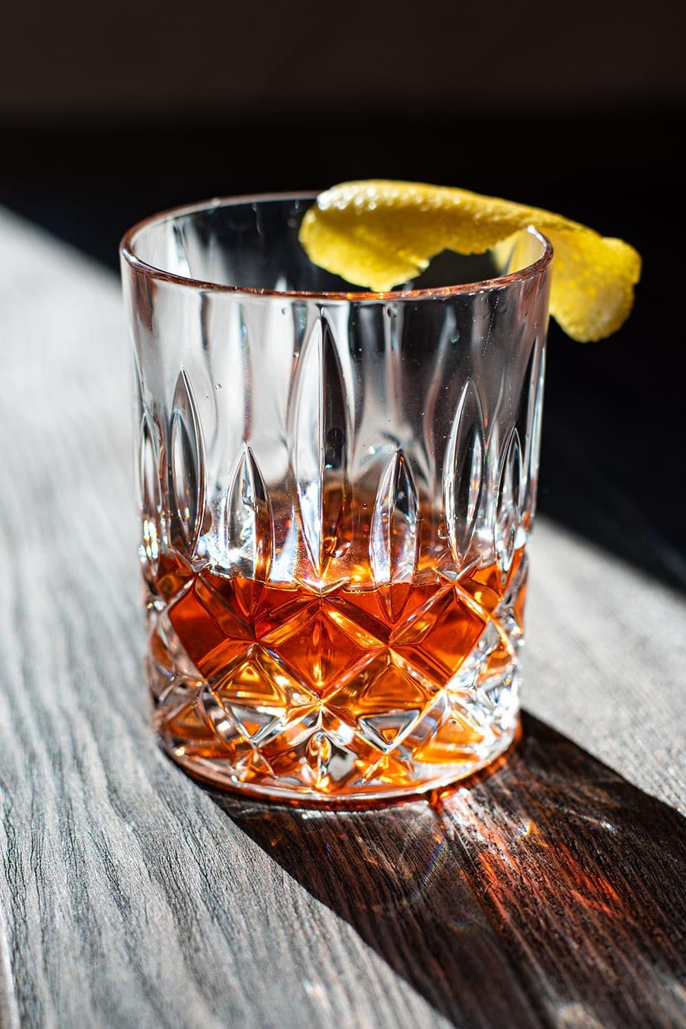 Sazerac cocktail in a rocks glass with lemon peel
