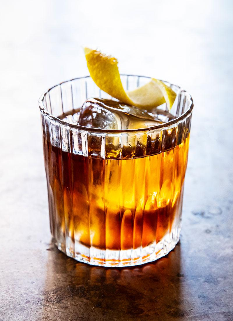 Vieux Carré cocktail in a lowball glass with clear ice and lemon twist