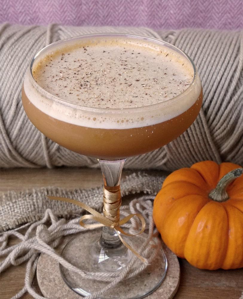 Sweater Weather cocktail in a coupe glass with cinnamon garnish