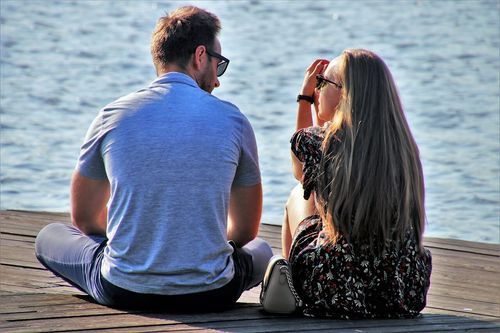 Couple sitting next to the lake